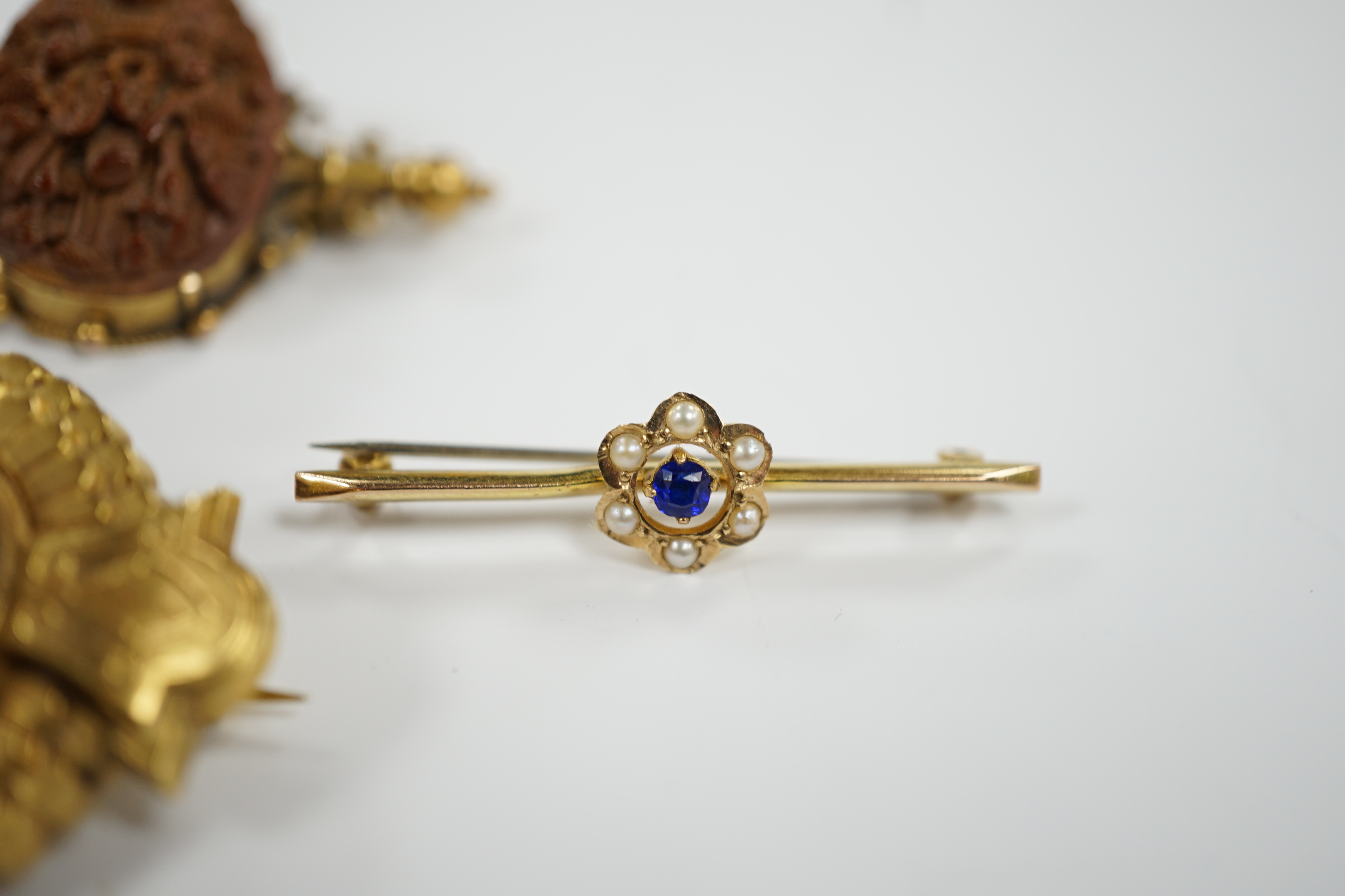 Four assorted yellow metal and gem set bar brooches including sapphire and diamond chip set buckle brooch, 51mm and two other yellow metal brooches, one set with diamond and split pearl